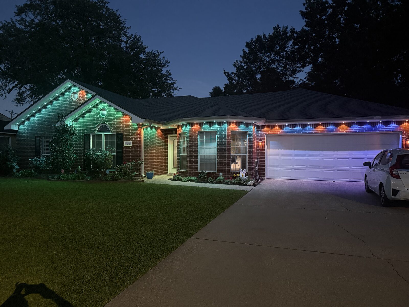 Sarah B.'s single-story brick home in Sulphur, LA at dusk with a GeauxTrax 150 ft kit and Govee Pro lights across the roofline